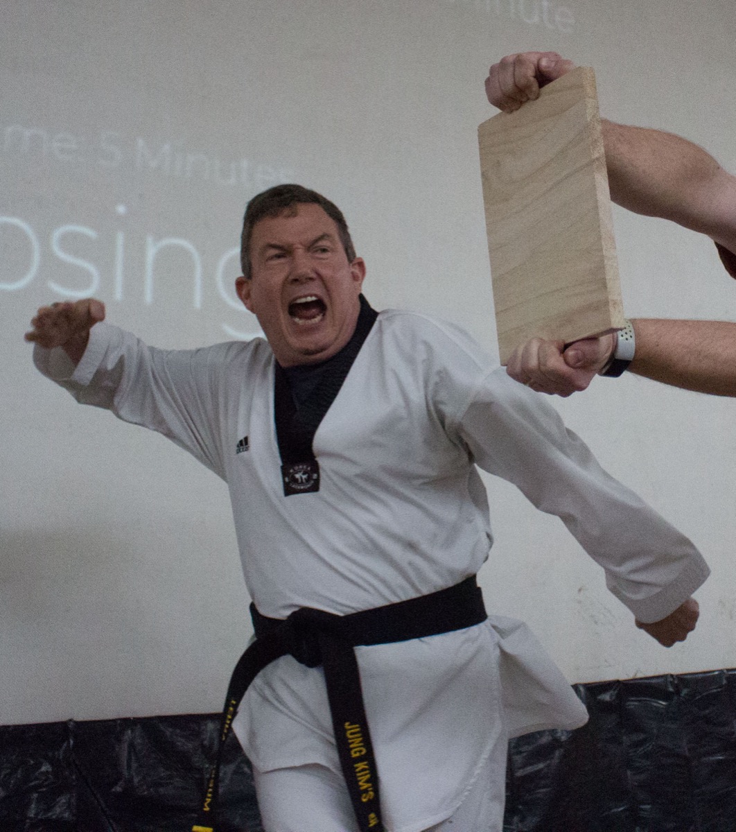 Terry Fossum breaking a board — black belt in Tae Kwon Do