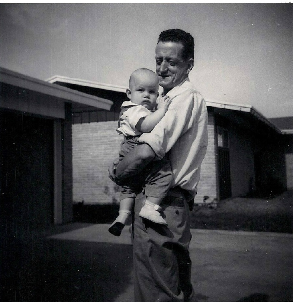Terry Fossum as a baby, held by his father